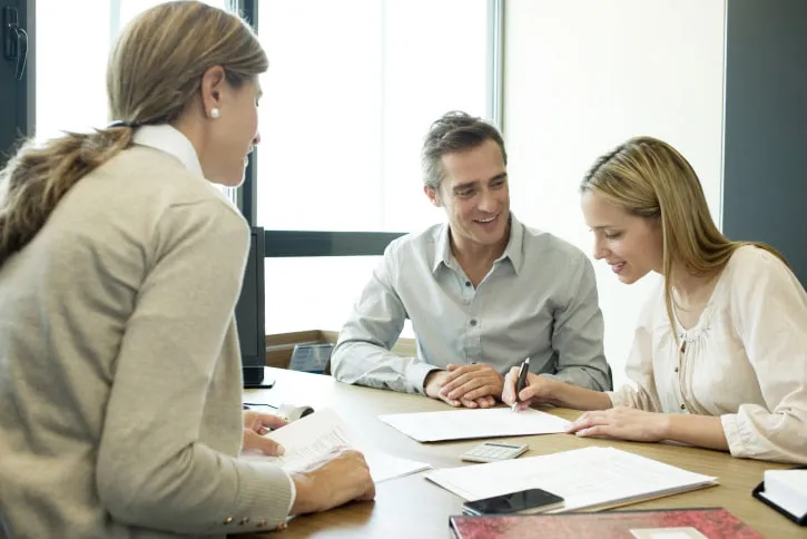 Couple reading over contract in office