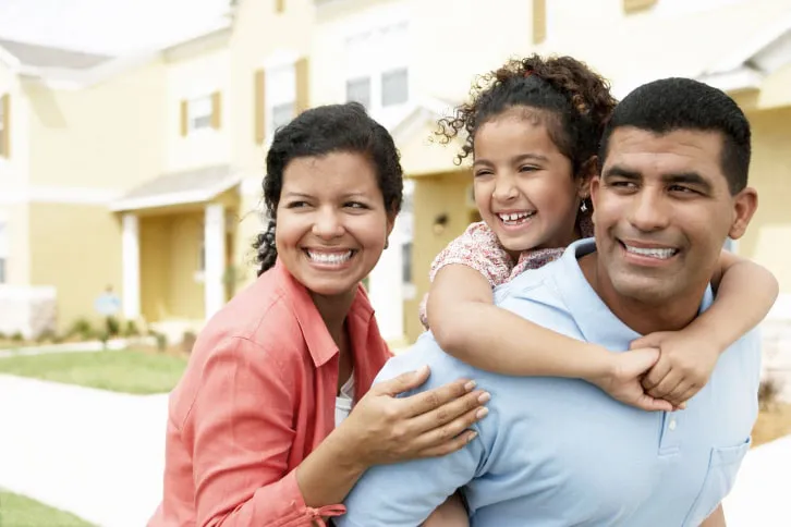 Playful Family in Front of Their House