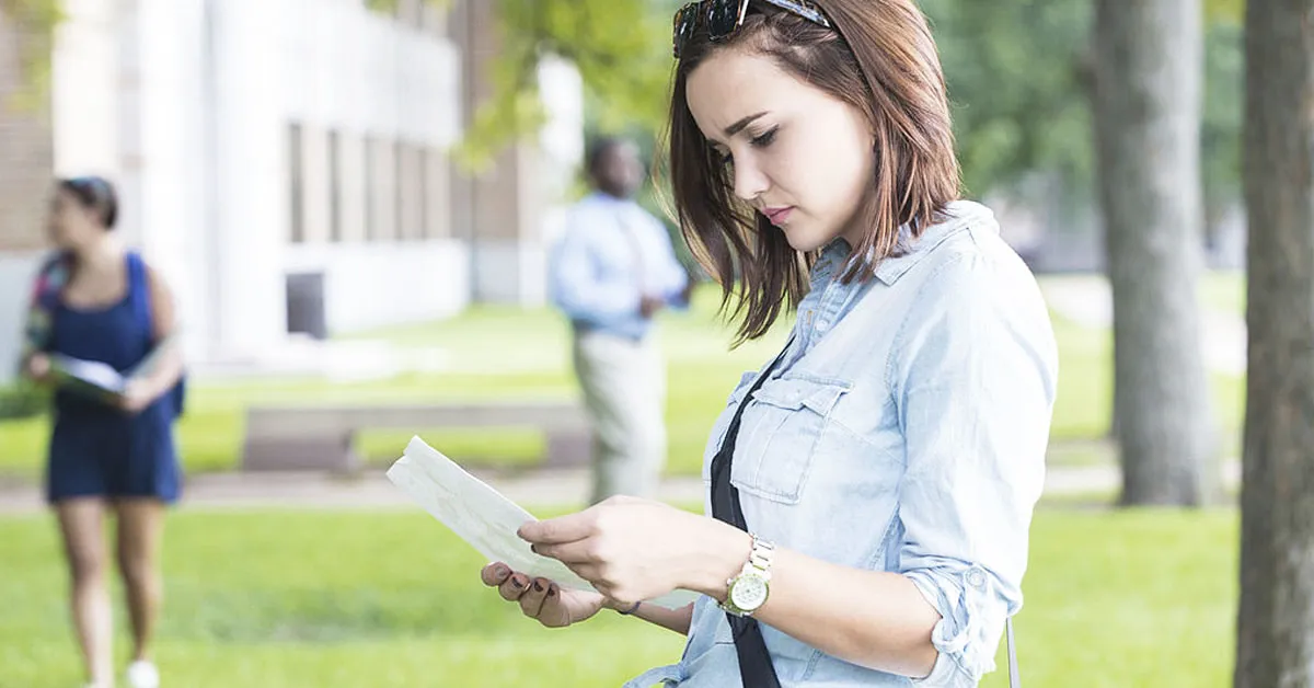 woman looking on paper she's holding seriously