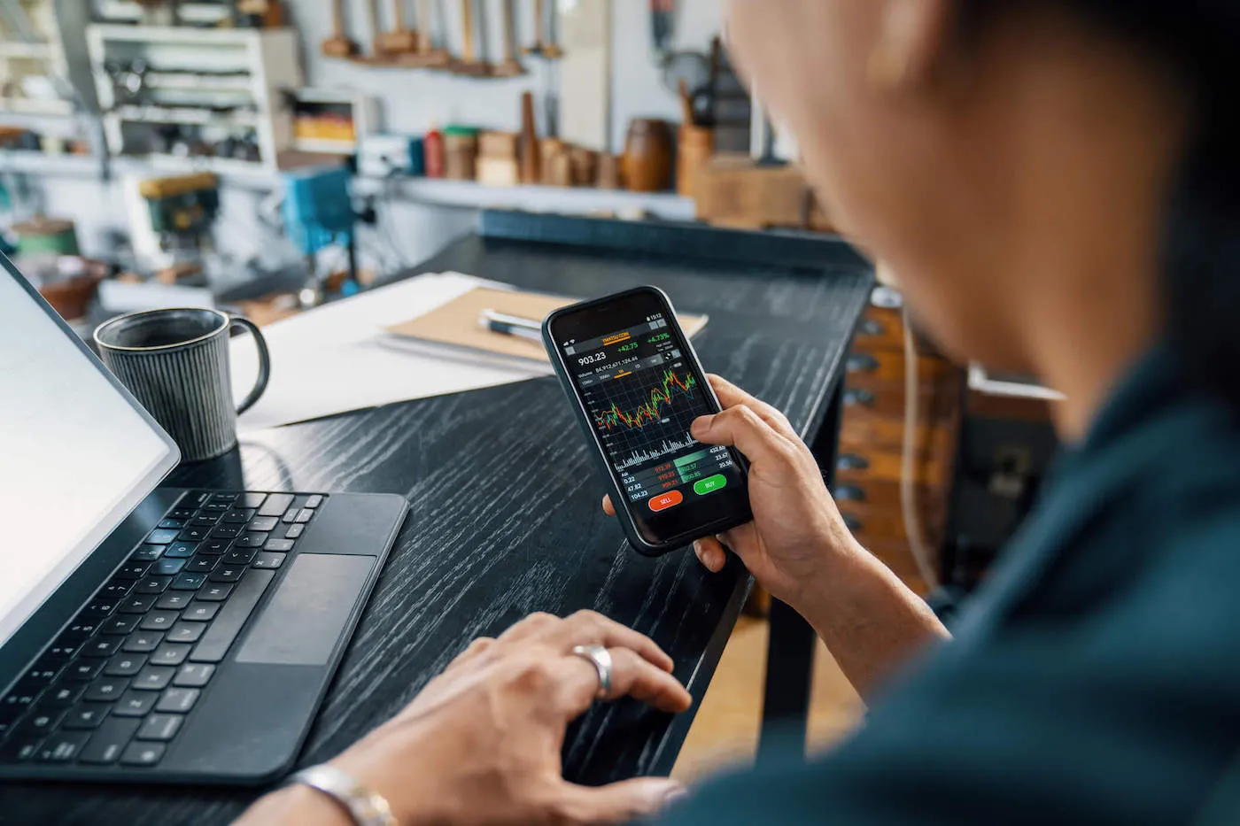 person on phone looking at high return investments