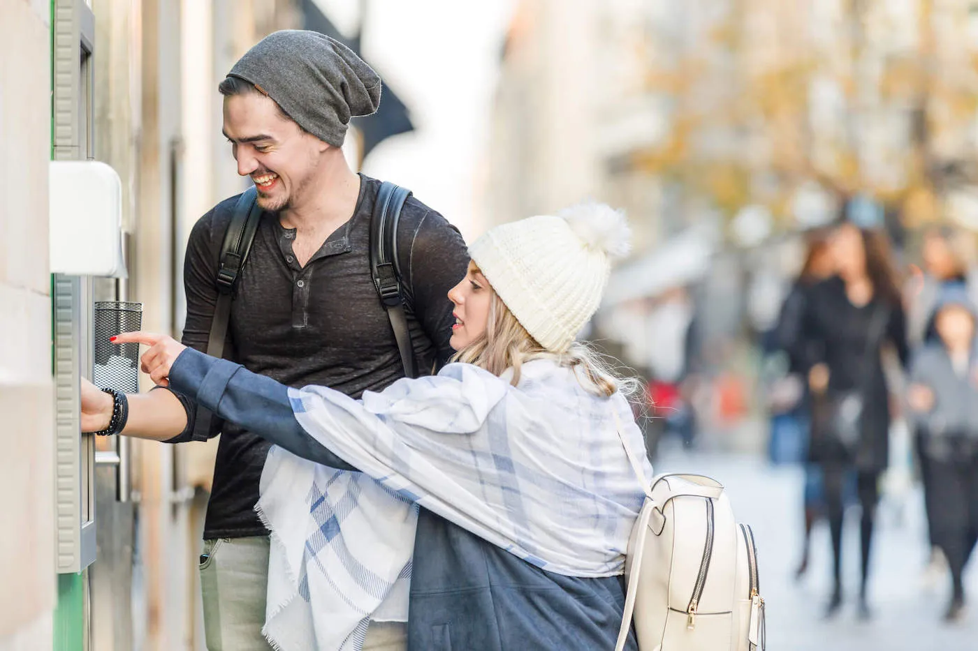 A Young Couple is Using ATM Machine and Withdrawing the Cash.