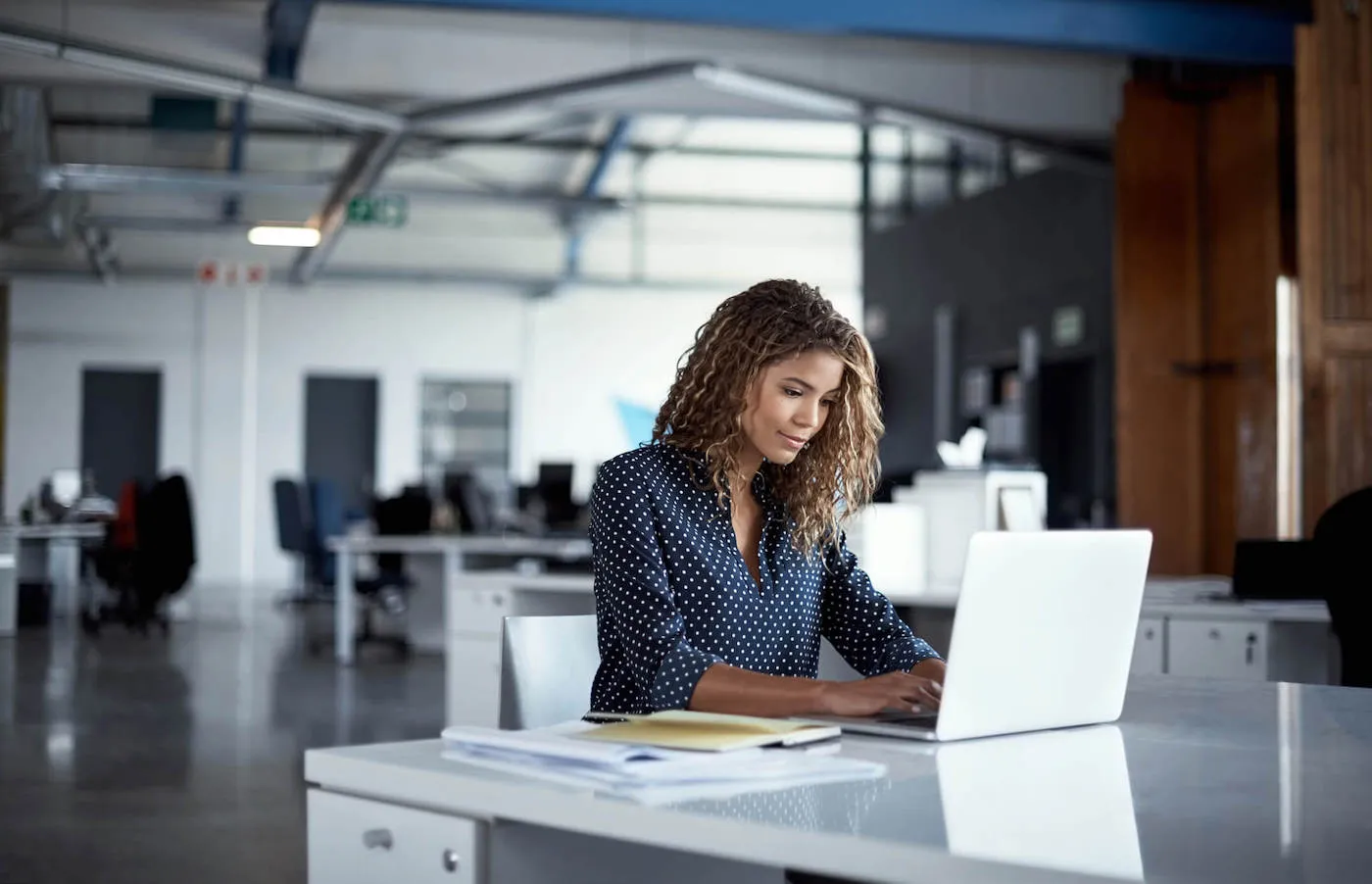 Cropped shot of a young businesswoman working on a laptop in a modern office.