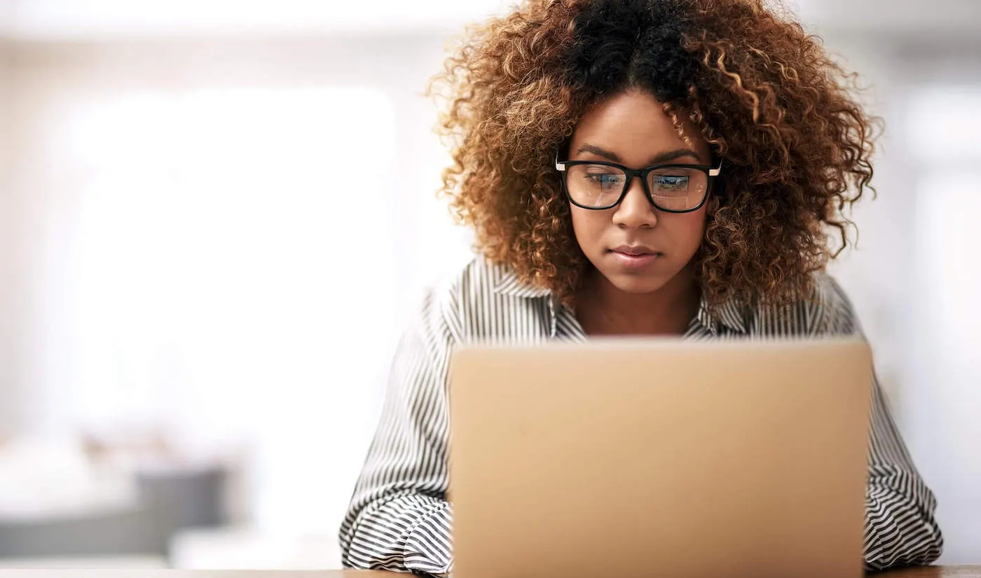 Cropped shot of a young woman working on her laptop.