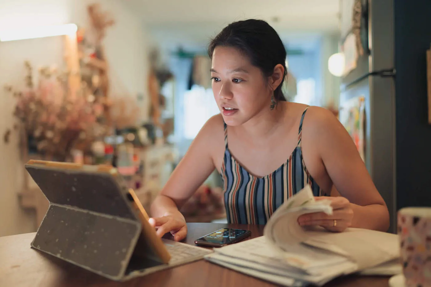 young woman searching on a tablet the difference between gross income and net income