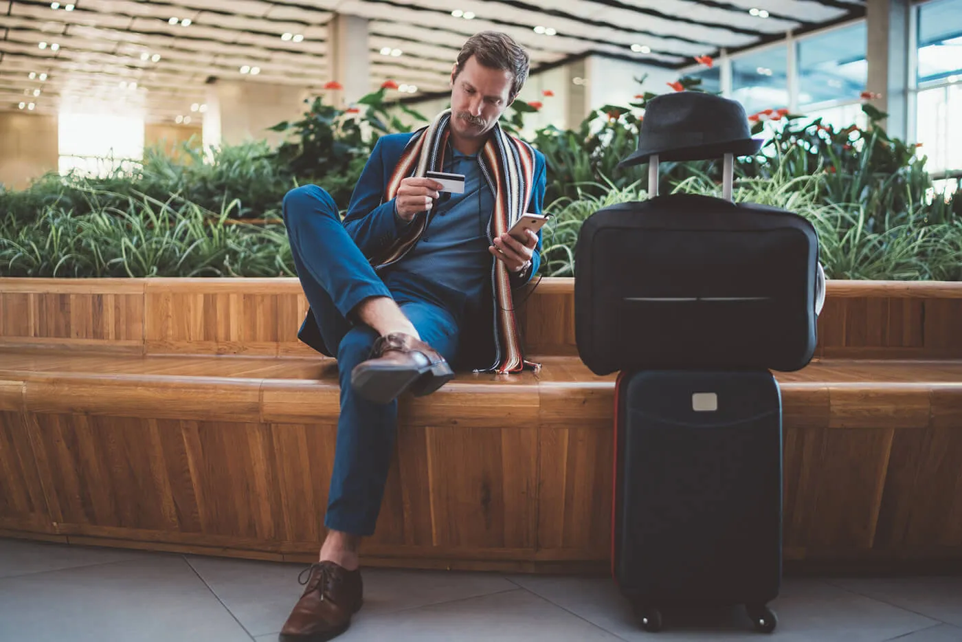 Businessman using online banking at the airport