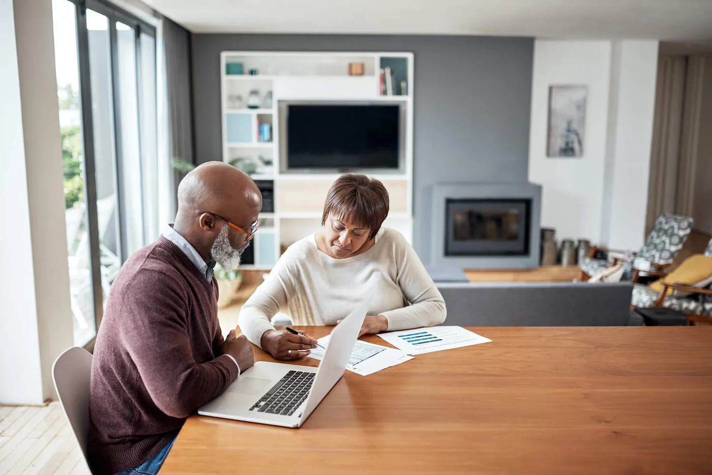 elderly man and woman couple seated at a desk researching how phase out ranges work