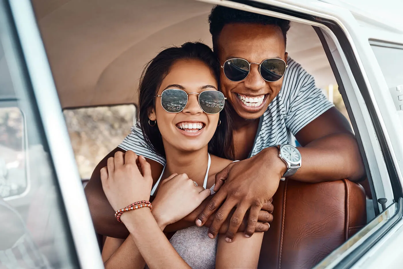 A happy young couple enjoying a road trip together