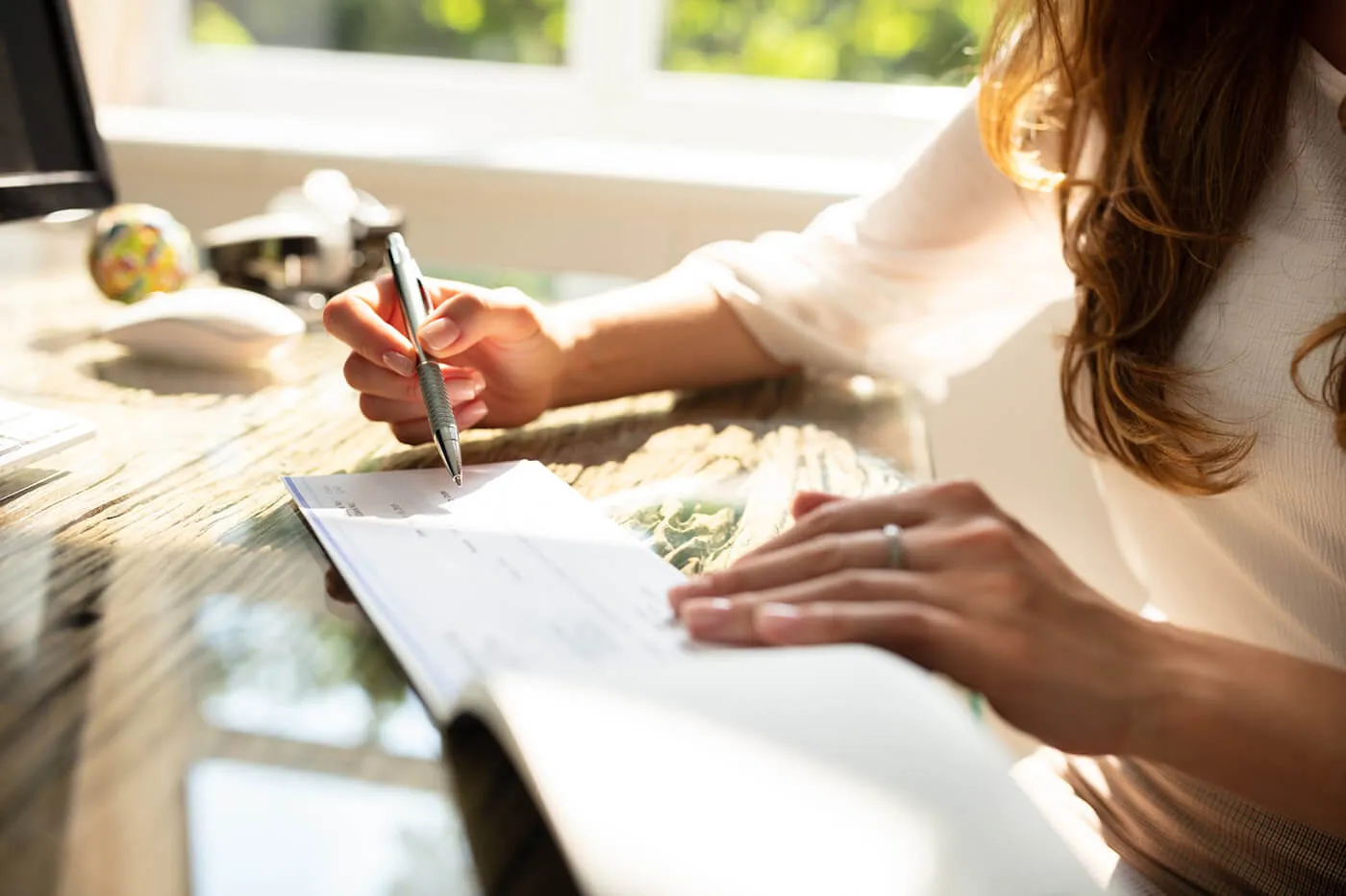 woman writing on paper making a retirement budget