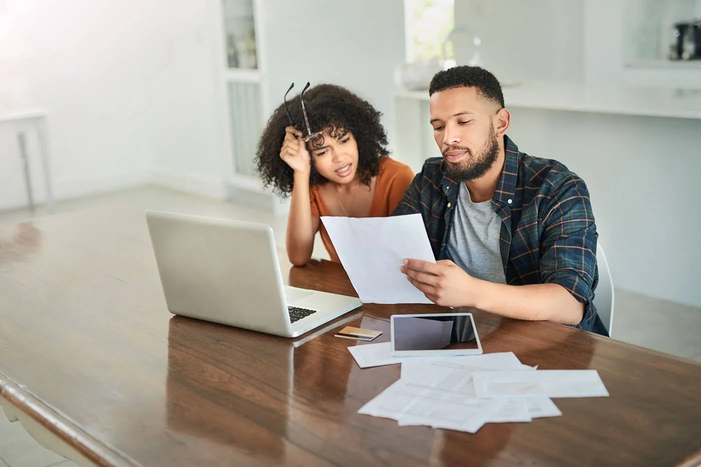 man and woman couple sitting looking over financial information