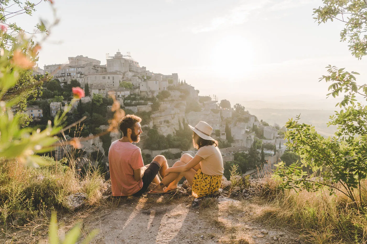 Young woman and man looking at scenic view of Gordes village in Provence