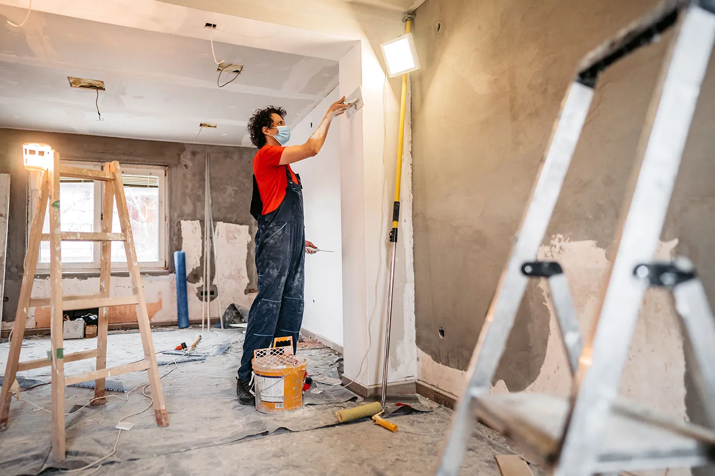 man repairing the interior of a house