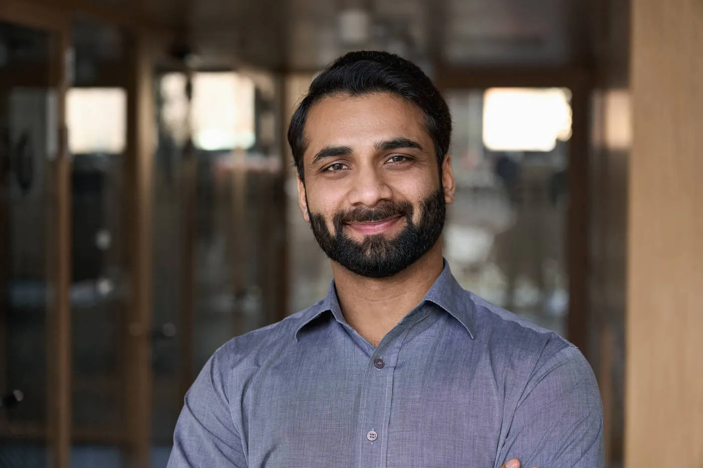 man with trimmed beard looking straight ahead smiling