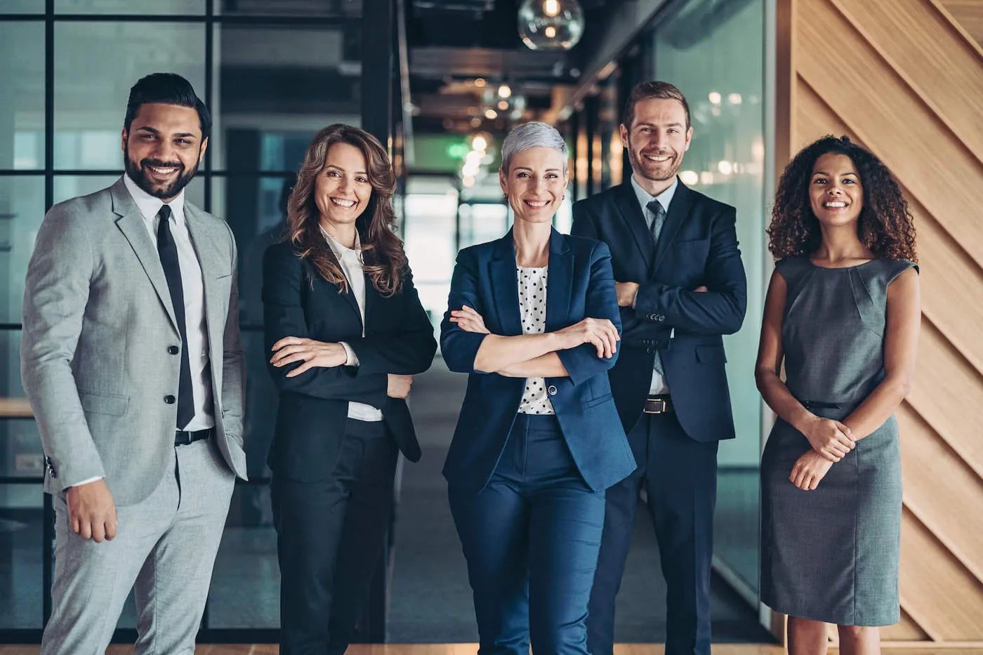 group of men and women in business dress smiling