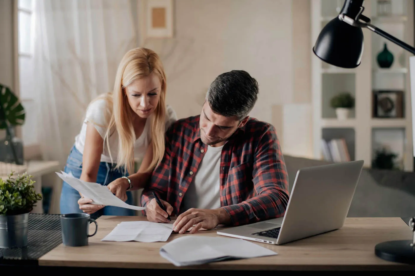 Worried young couple with financial bills.