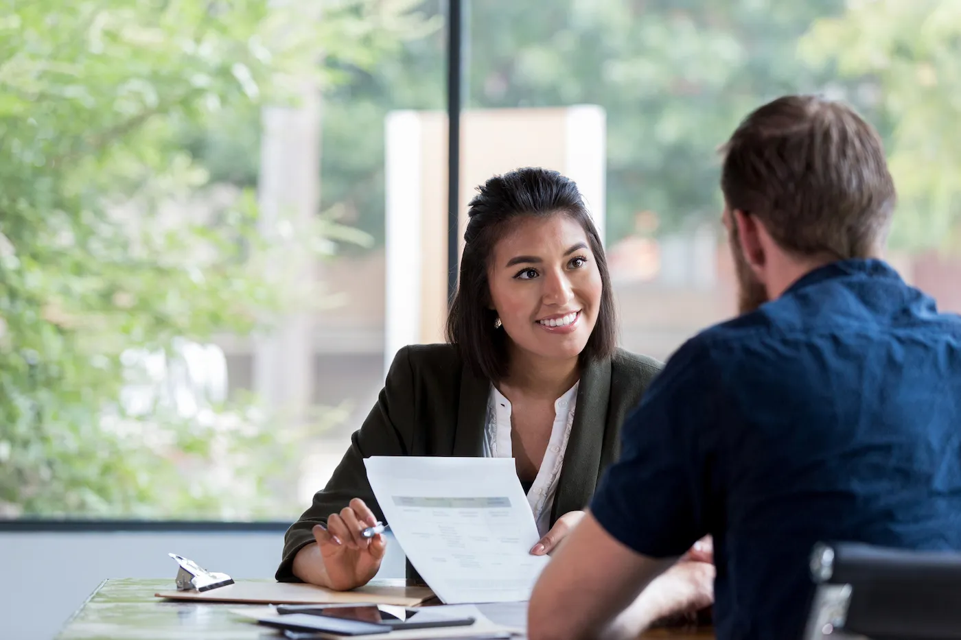 A banker helping a client take out a personal loan