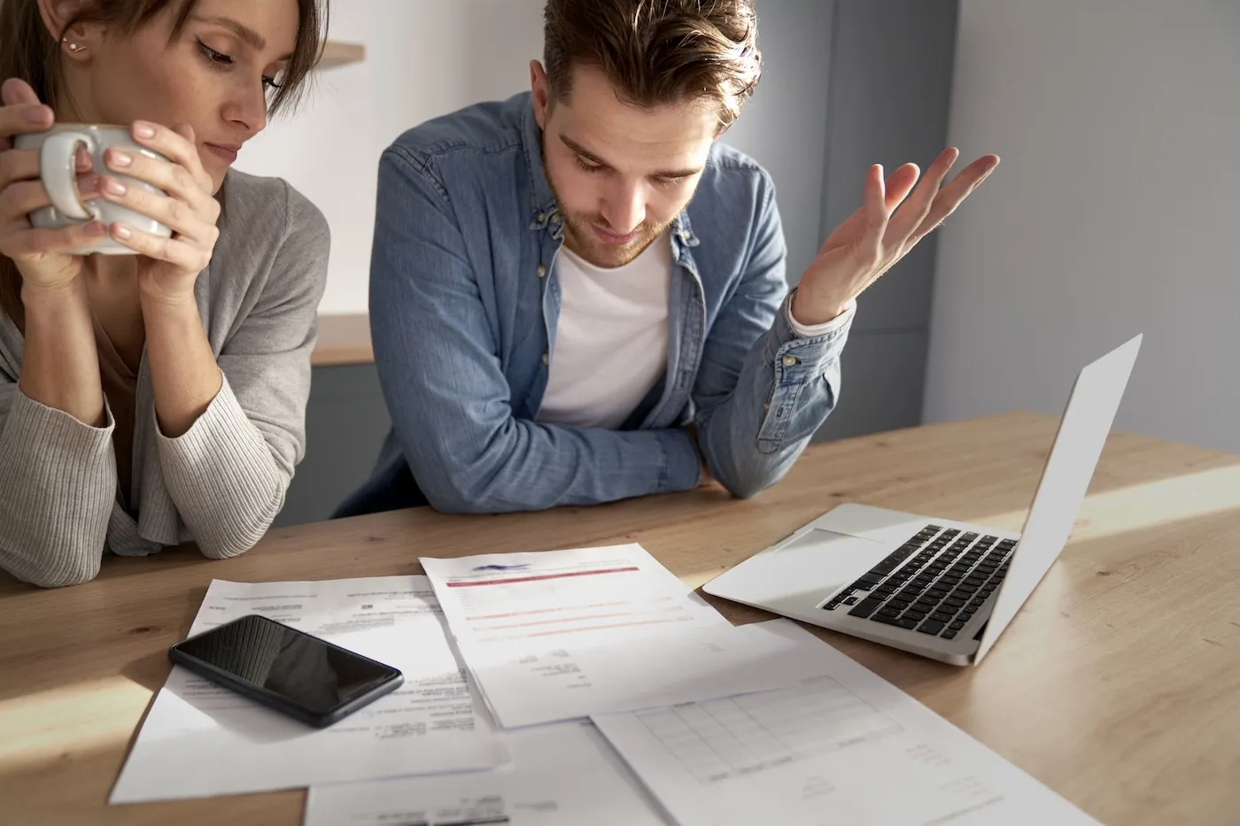 Miserable young couple having financial problems due to bankruptcy.