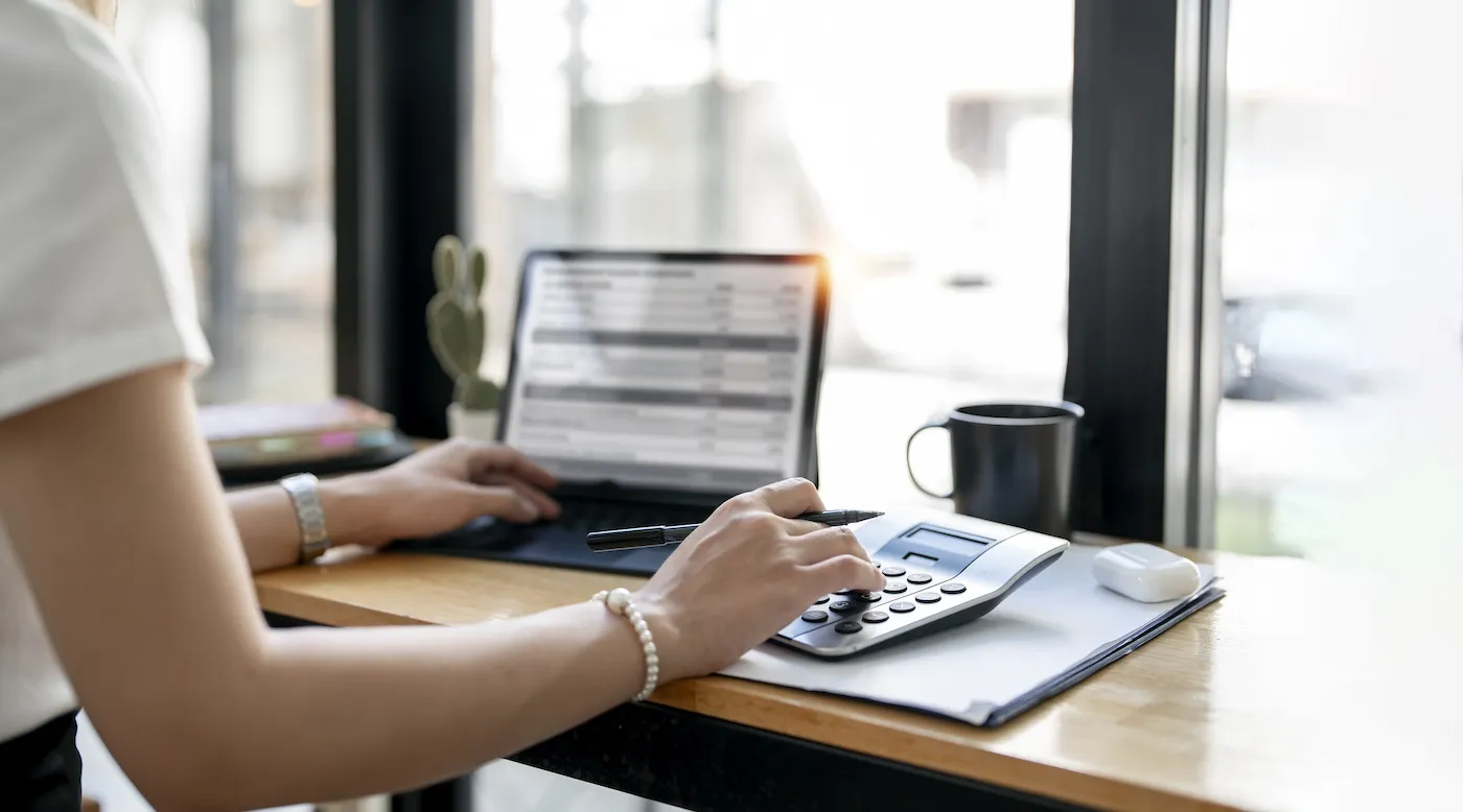 A woman calculating credit card utilization