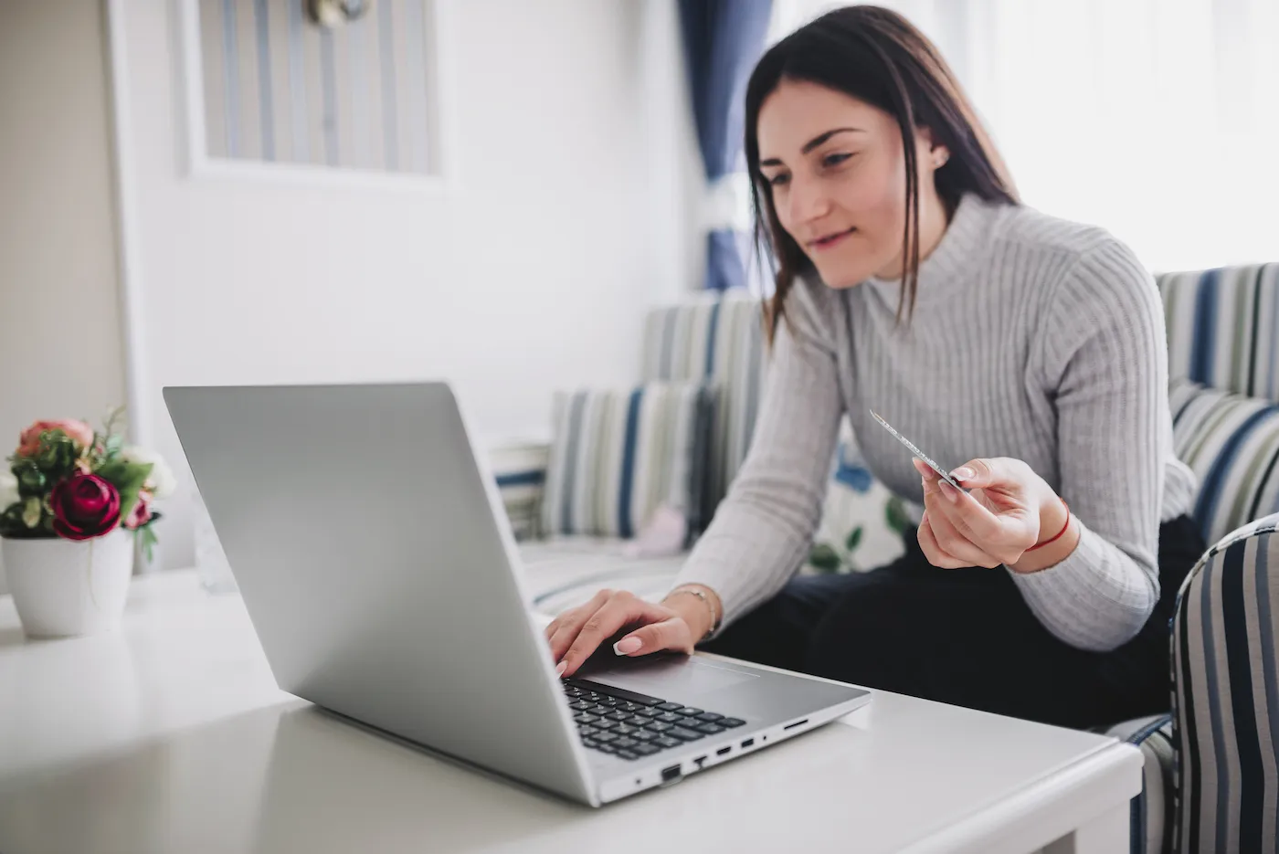 Young woman at home applying for a credit card at bankruptcy