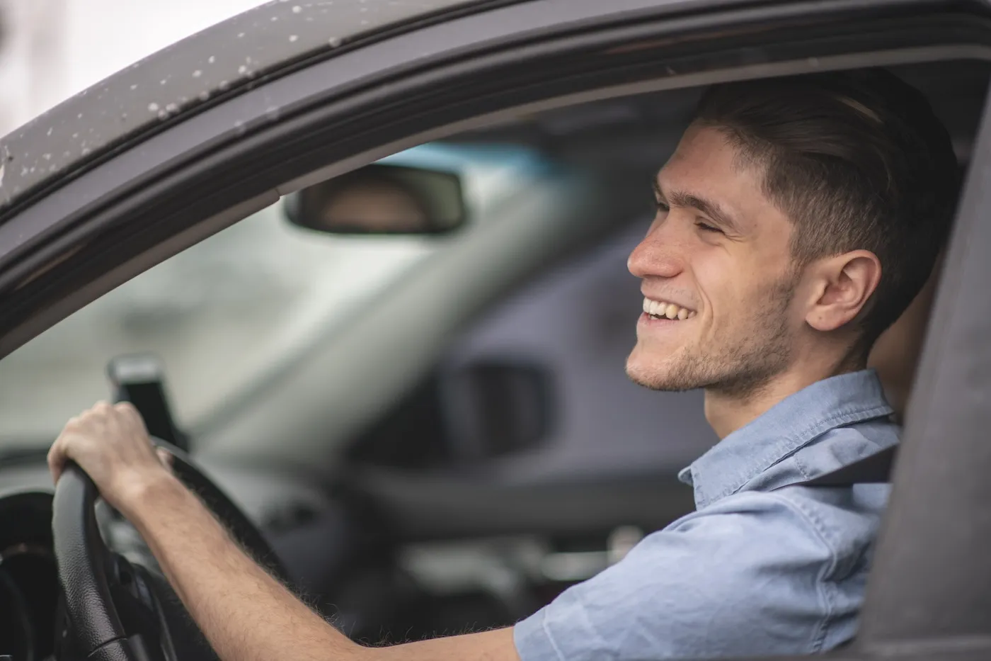 A man driving a car with an insurance policy.