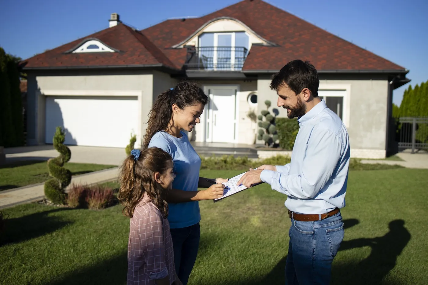 Woman signing a contract and selling her house.