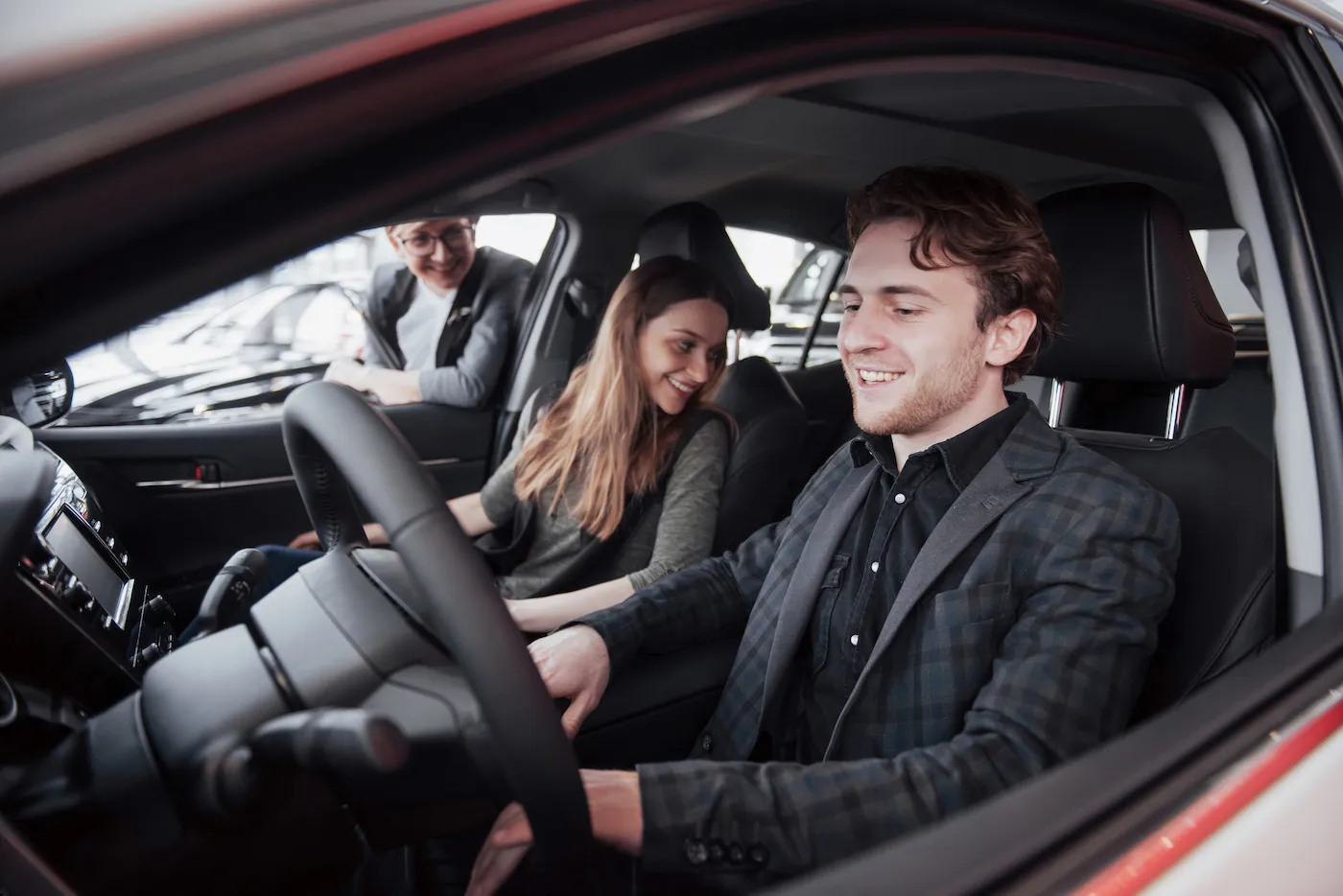 Couple sitting in a car while buying from a private party