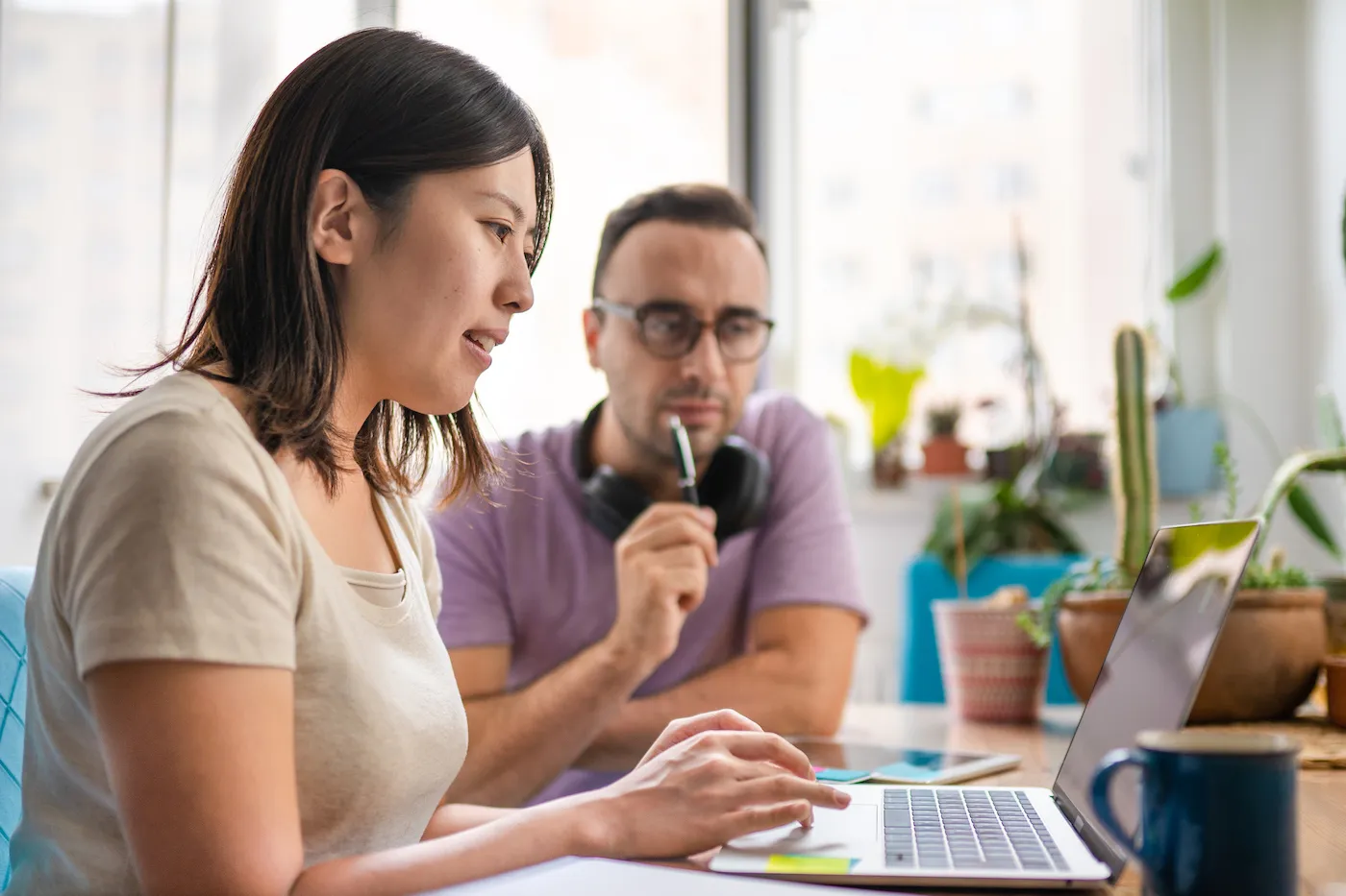 Young man and woman working at home and exchanging information about work