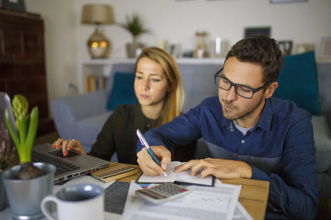 A couple working on their finances together, trying to refinance their mortgage