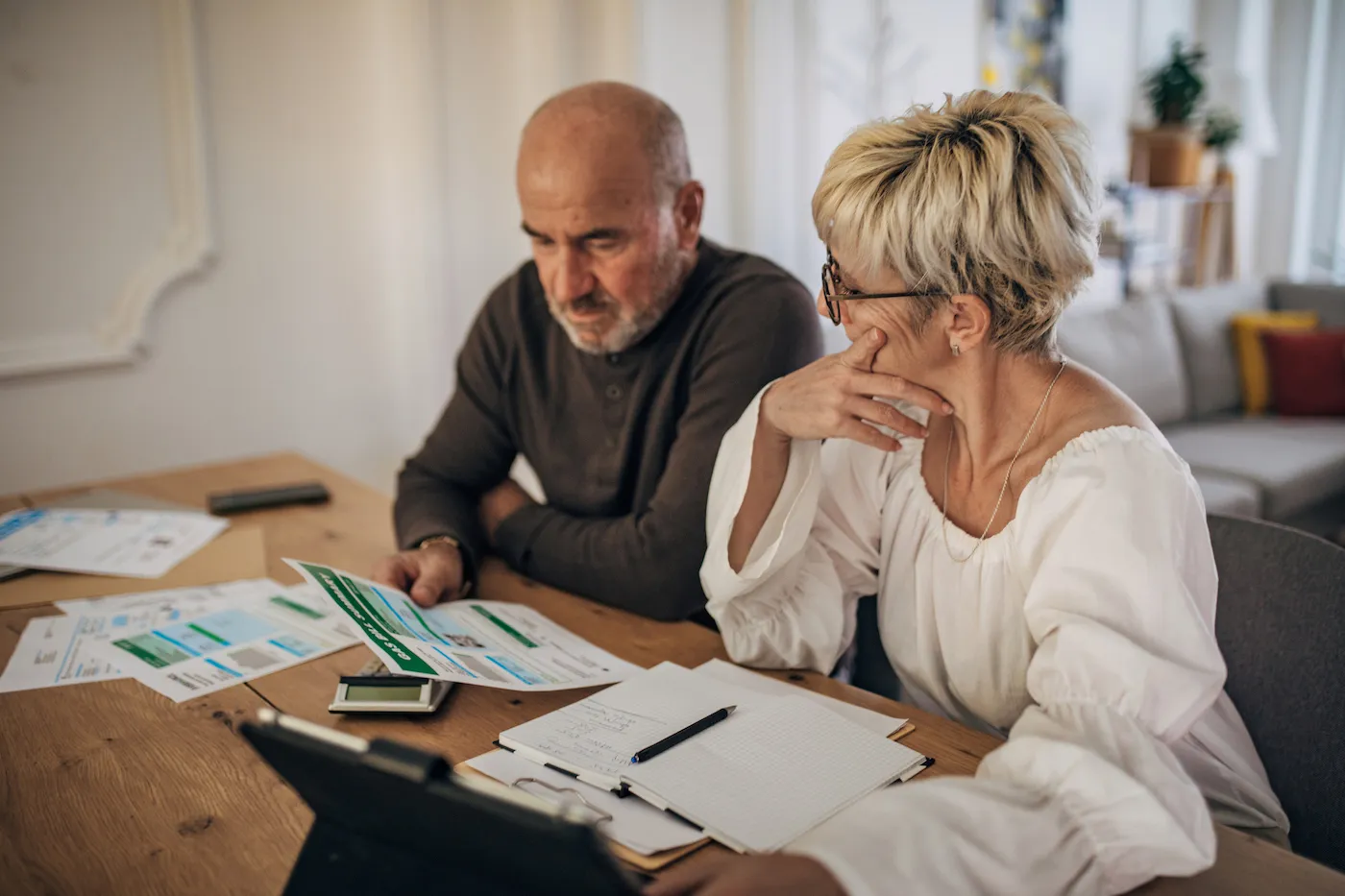 Couple calculating bills and debt and trying to organize to pay them