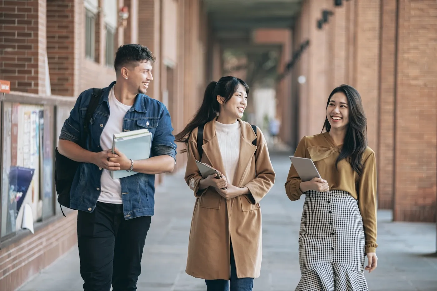 Three university students walking together during back to school