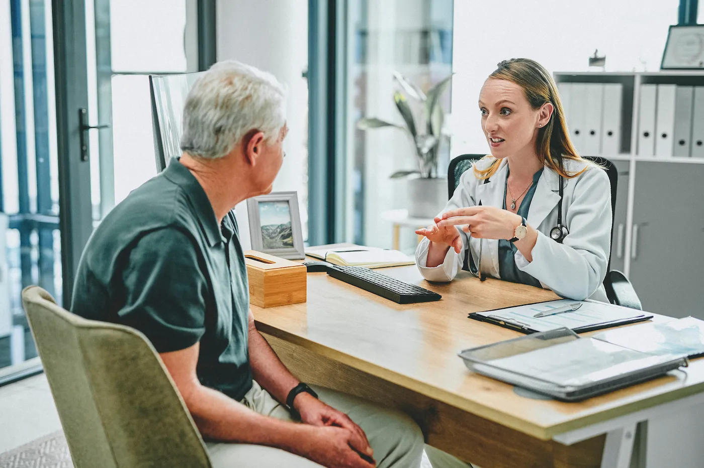 Doctor explaining Medicare to elderly patient