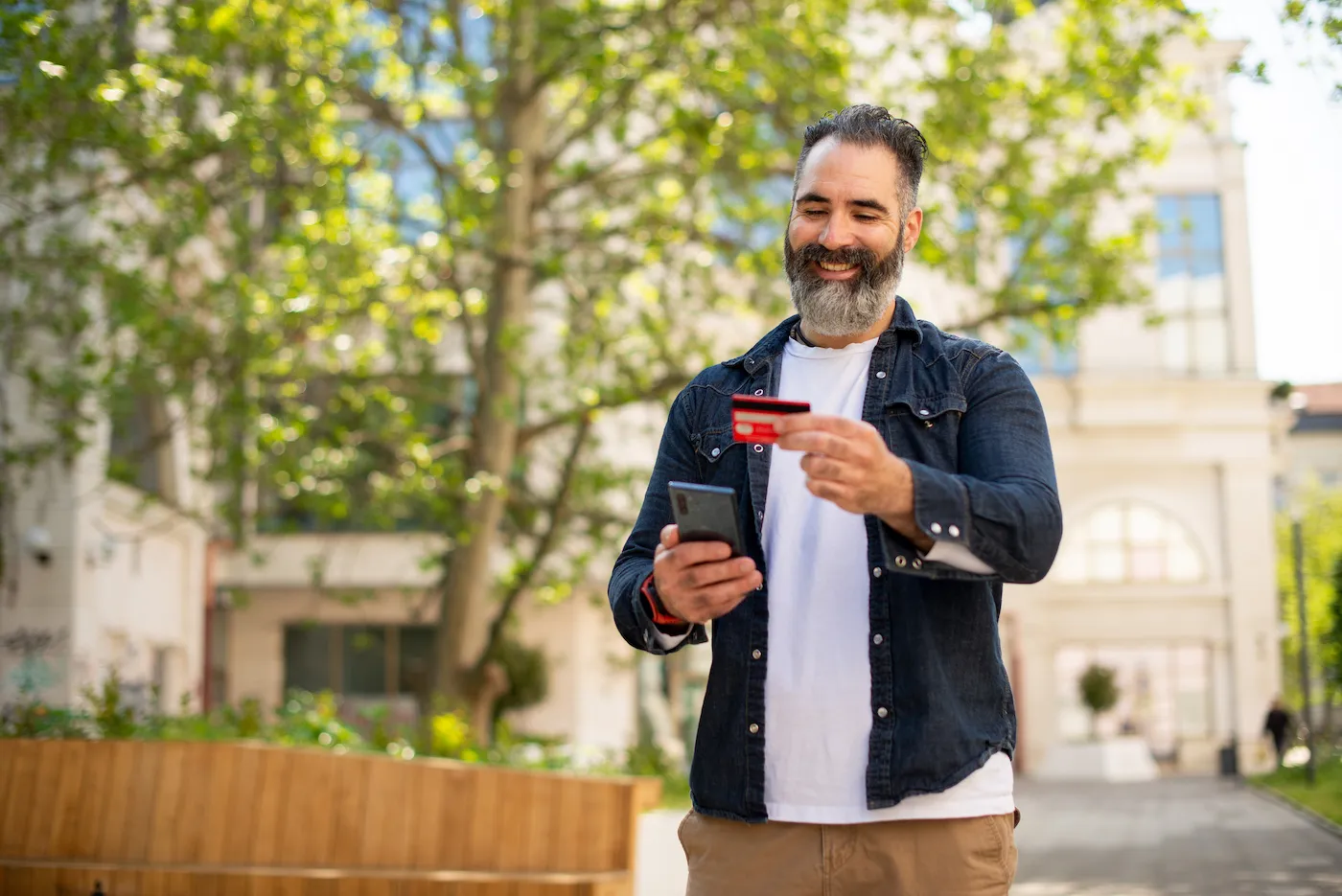 Man using credit card outside