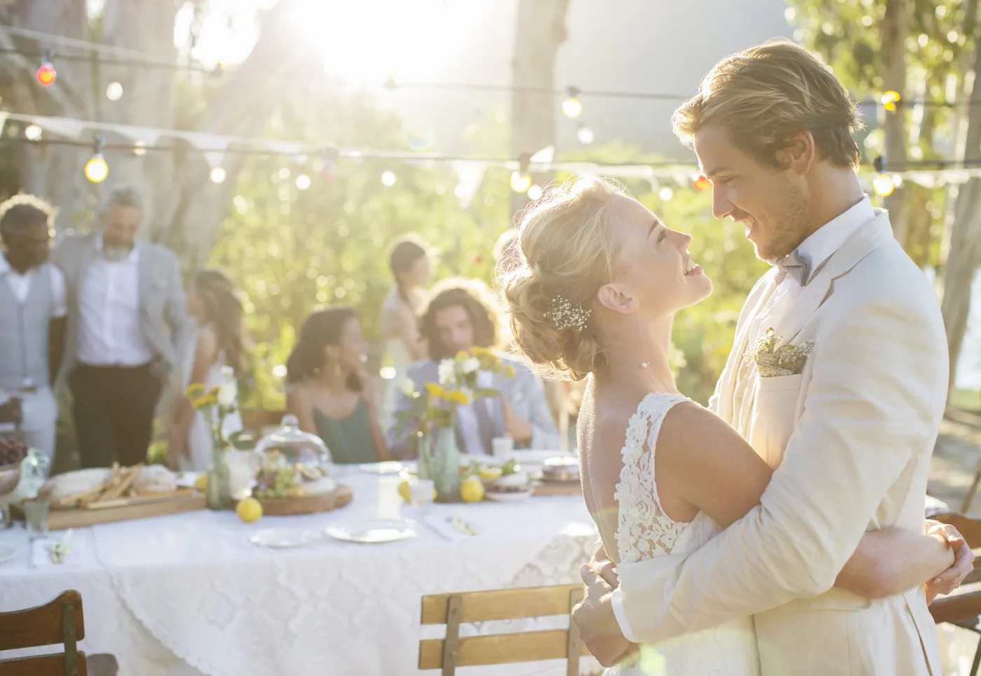 Young couple dancing during wedding reception in domestic garden