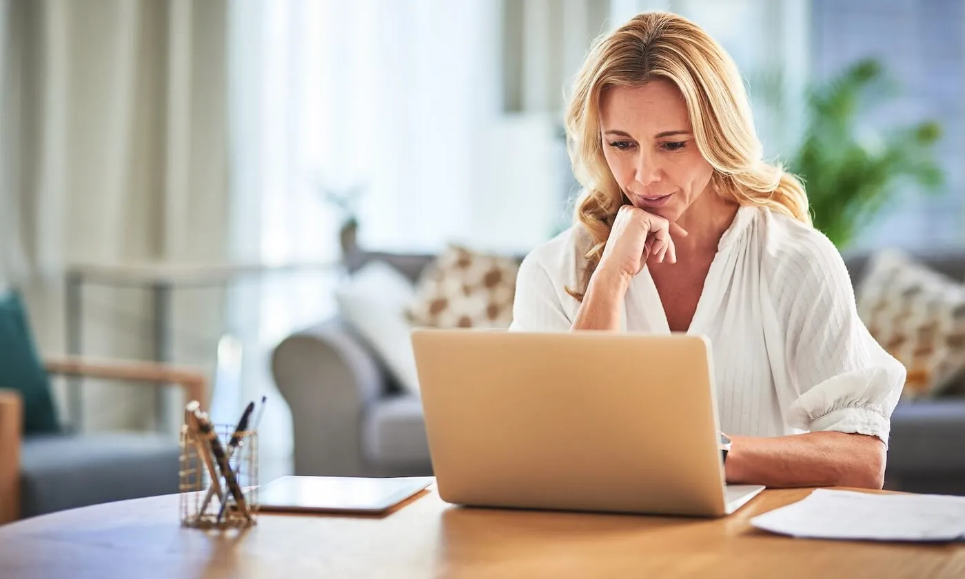 Woman working on her laptop in the living room