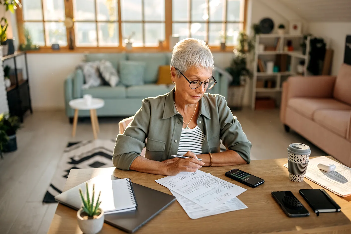 Senior woman calculating her retirement on social security at her apartment