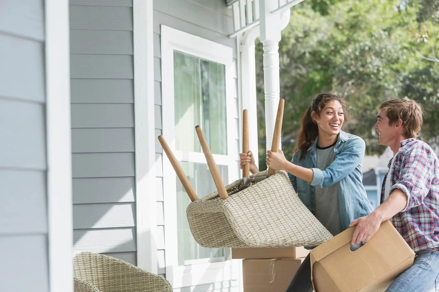 Young couple moving the furniture to their new home