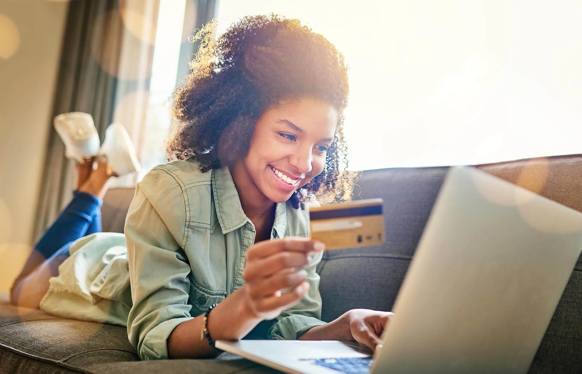 Girl Checking Credit Card on Laptop