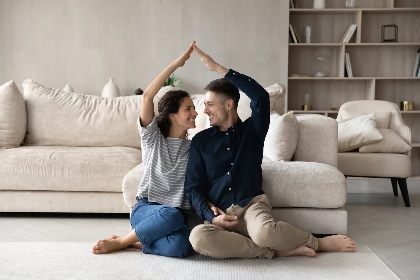 Happy homeowners celebrating having mortgage insurance