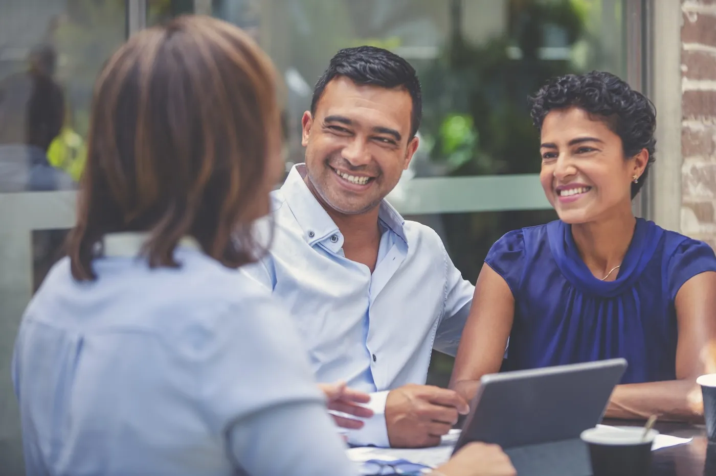 Happy couple having a business meeting with a financial advisor.