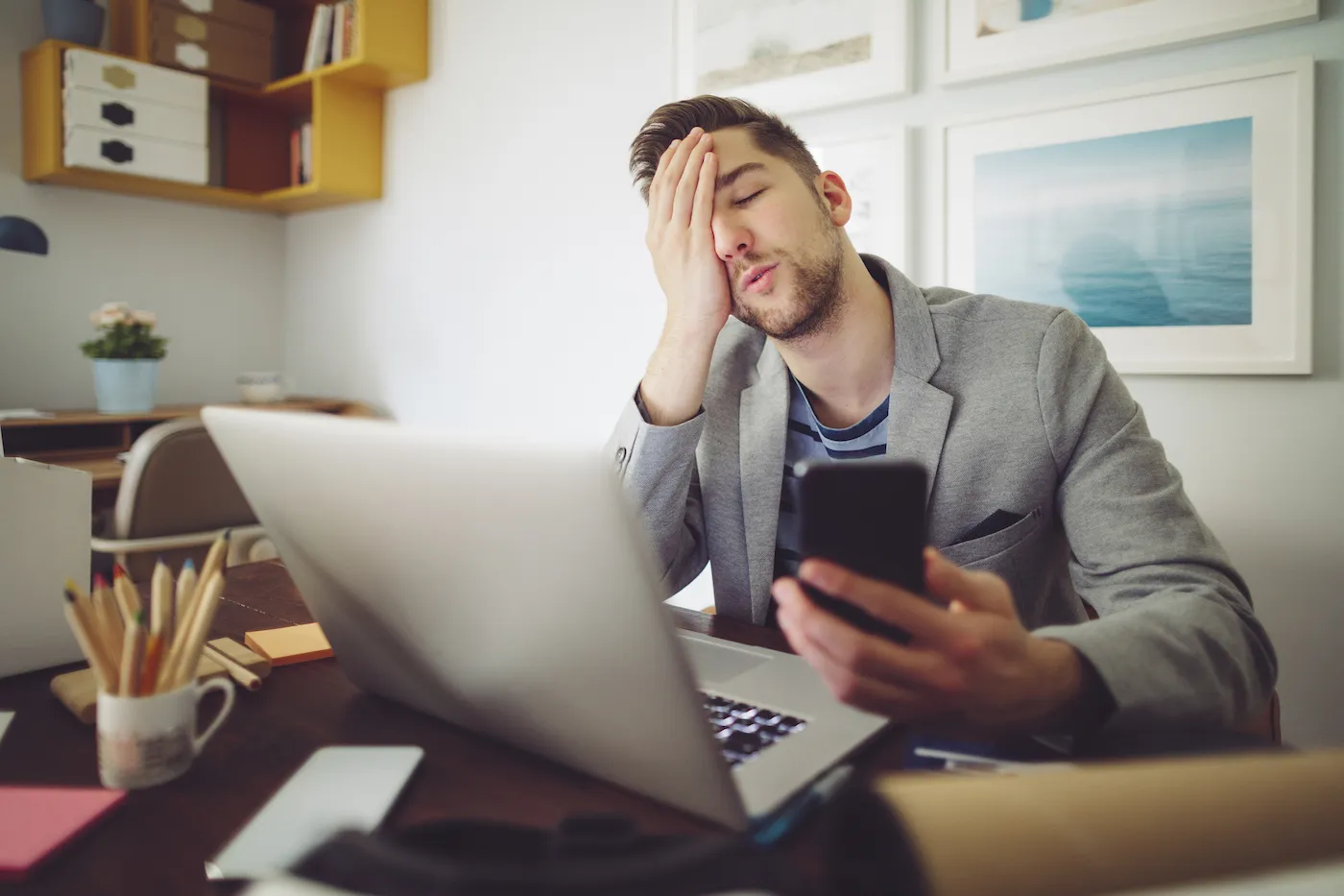 A man checking his credit after a foreclosure, looking stressed.