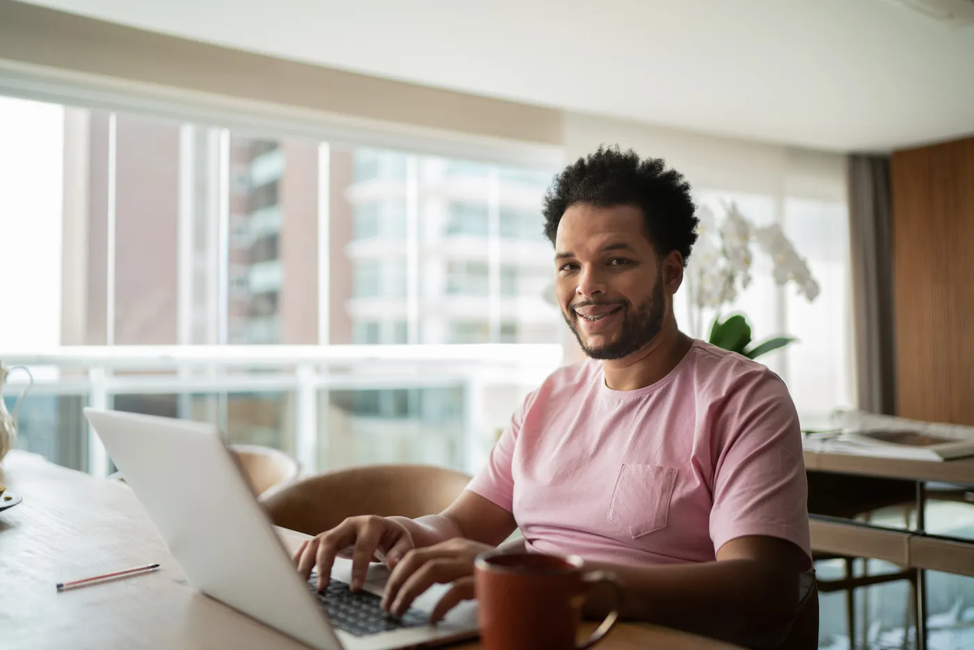 Portrait of a man budgeting at home with multiple accounts