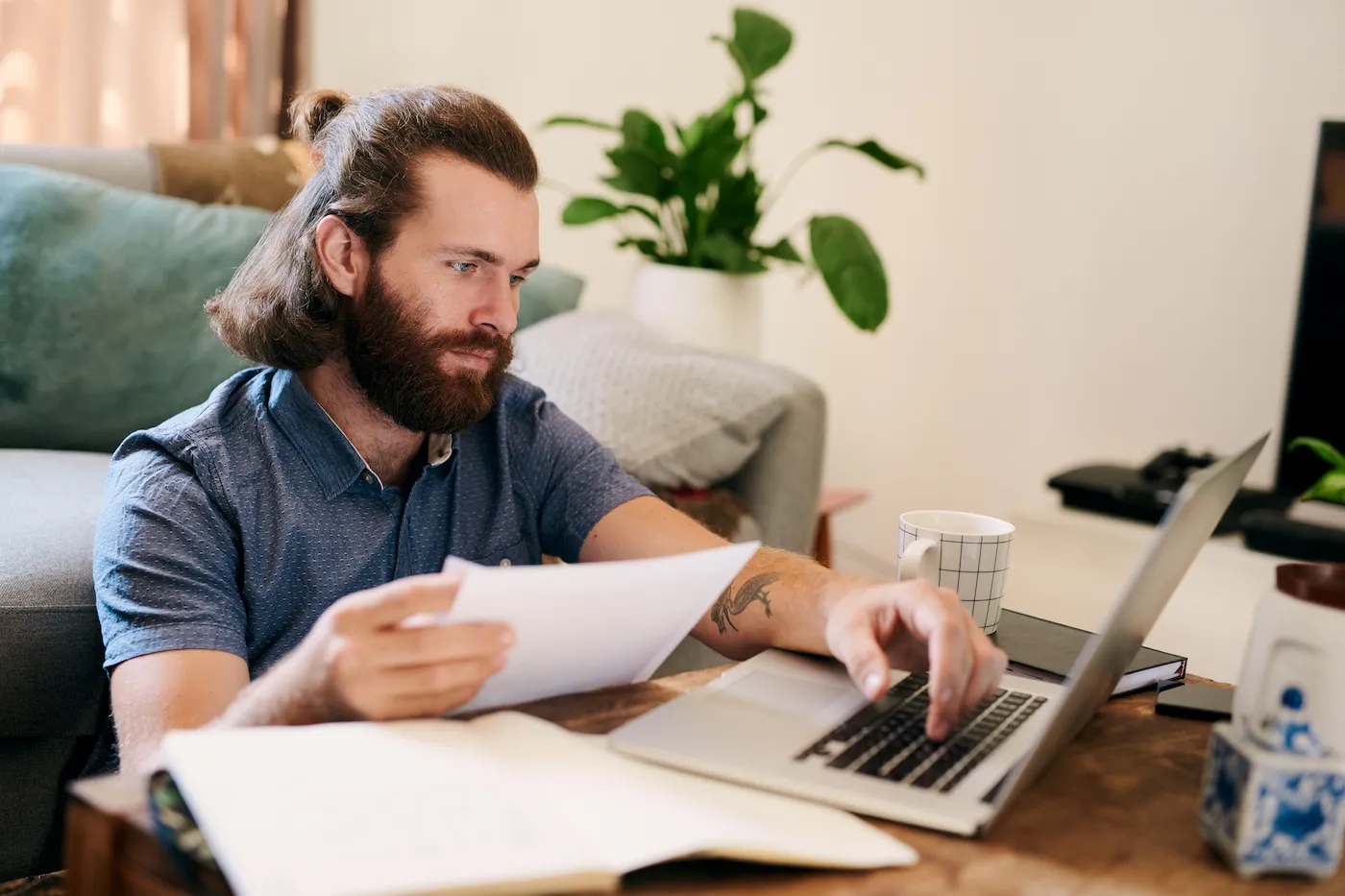 Cropped shot of a young man working on finances at home, learning where to borrow money