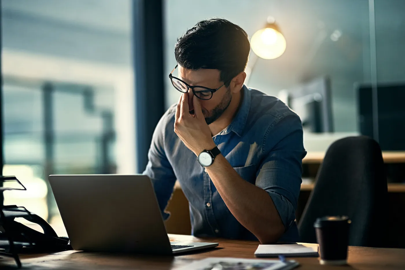 A man stressed about being caught in a debt cycle.