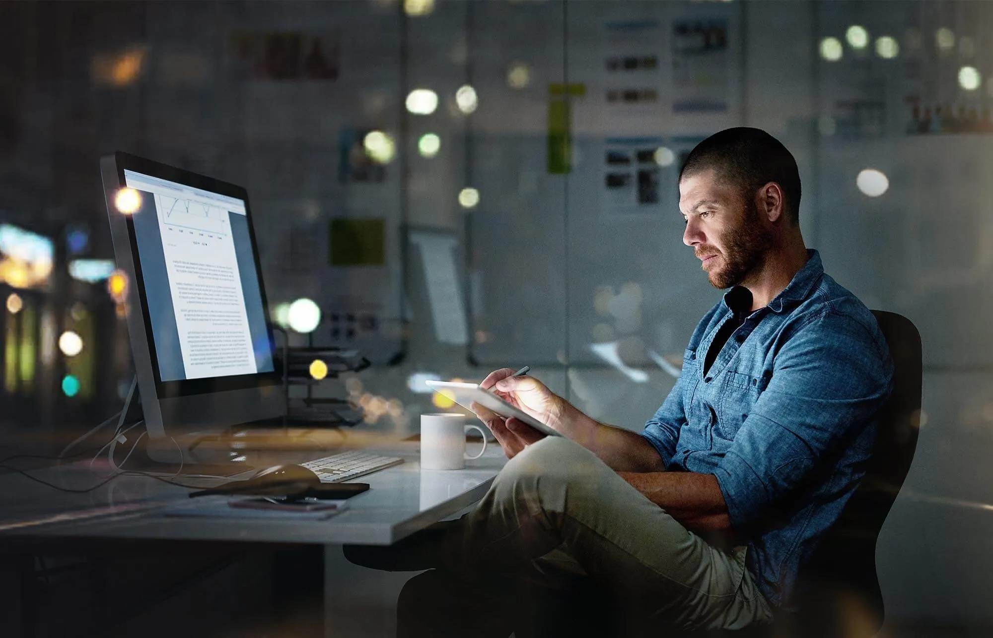 Man Reviewing Finances on Devices