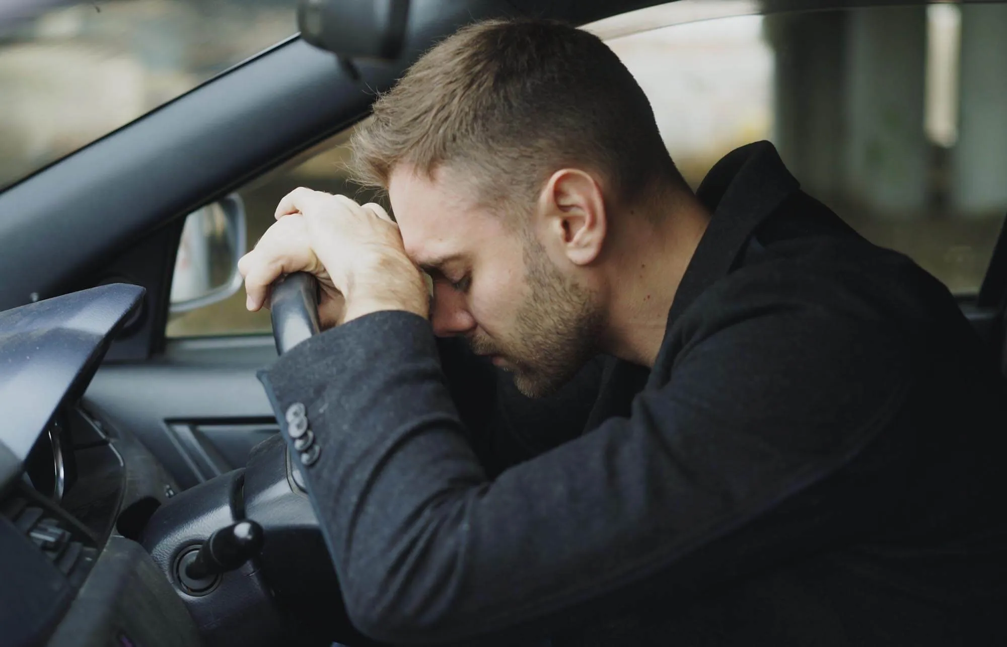 Man Stressing Inside Black Vehicle