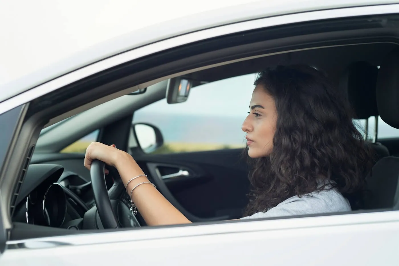 Young woman driving a white car