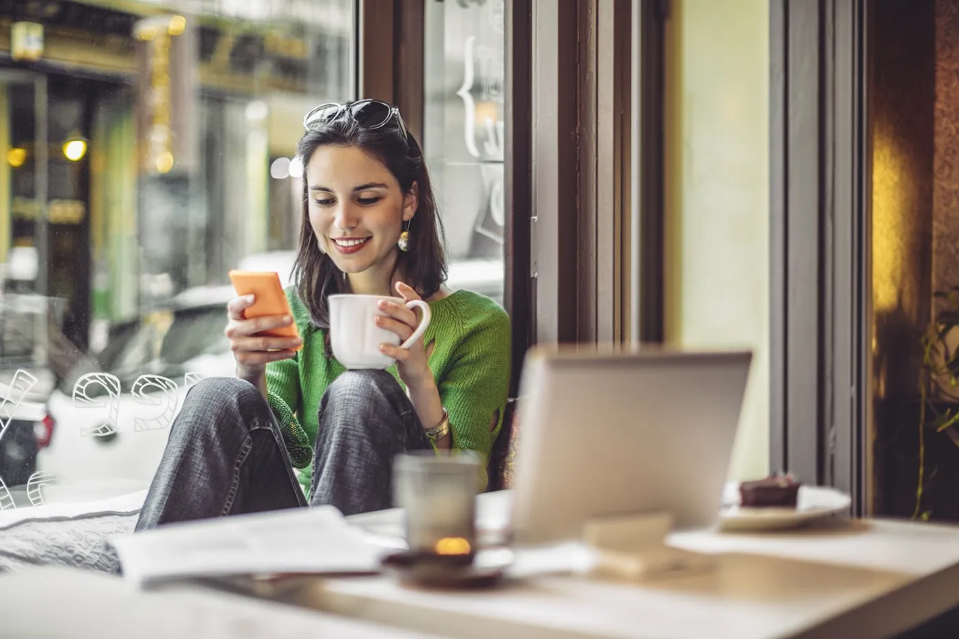 Young woman enjoying a cup of coffee on a rainy day