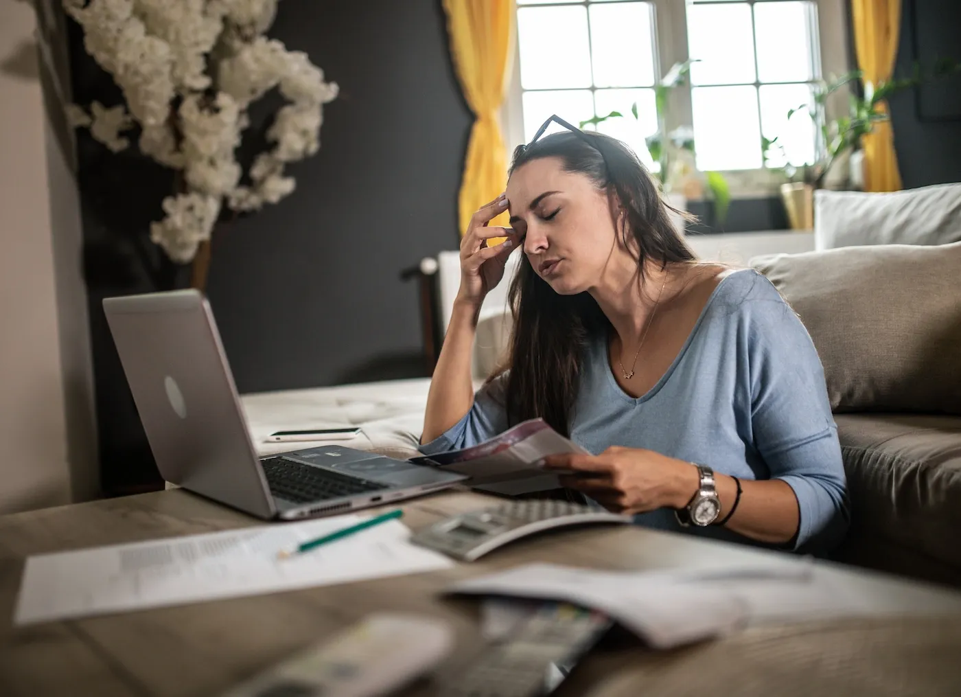 Woman analyzing documents while sitting at home