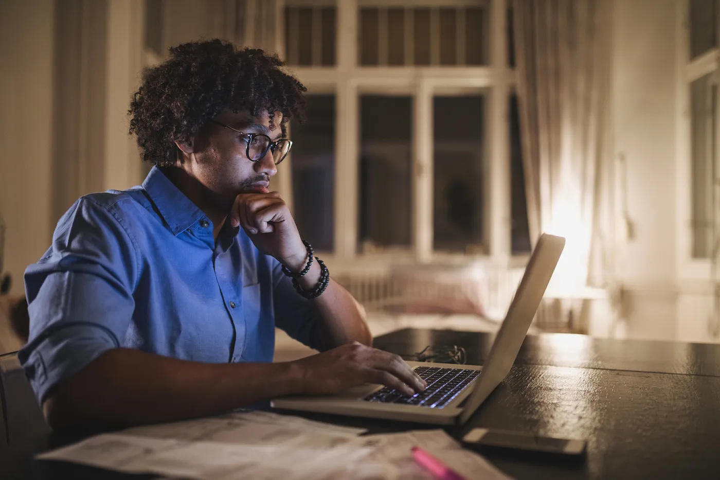 Focused man doing his income taxes on a laptop computer.