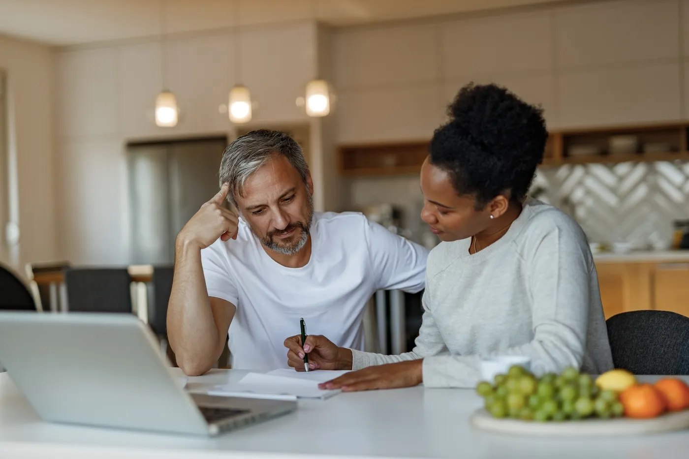 A couple doing financial planning at home.