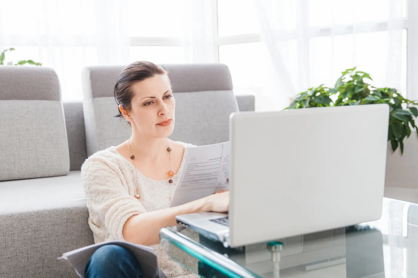 Woman using laptop computer at home.